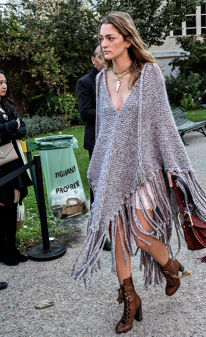 How to wear woven poncho, Sofia Sanchez de Batek wearing grey woven poncho, Paris Fashion Week street style fashion by PeopleandStyles.com