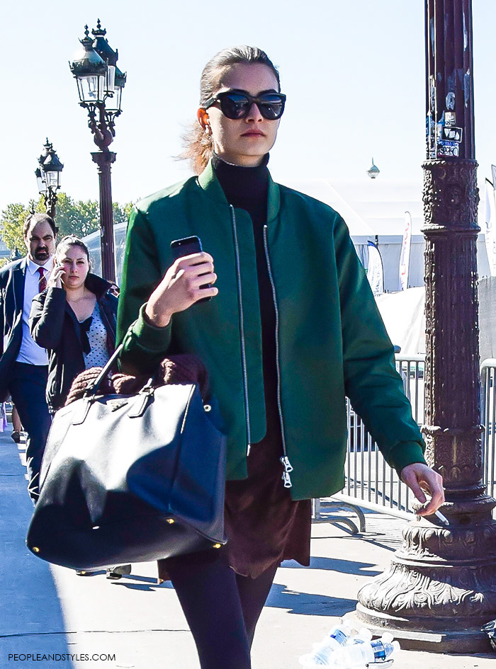 How to wear green bomber jacket, turtleneck, brown mini skirt, Prada tote bag and biker boots. Model off duty look, street style fashion Paris, what to wear now