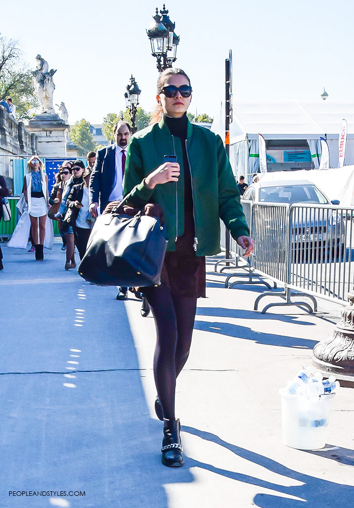 How to wear green bomber jacket, turtleneck, brown mini skirt, Prada tote bag and biker boots. Model off duty look, street style fashion Paris, what to wear now