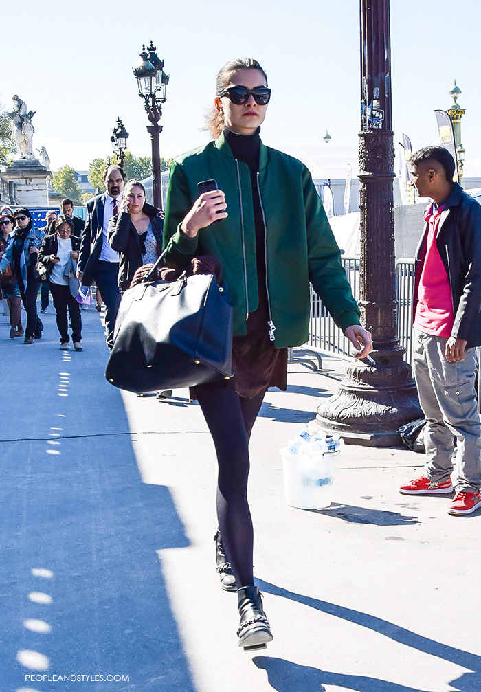 How to wear green bomber jacket, turtleneck, brown mini skirt, Prada tote bag and biker boots. Model off duty look, street style fashion Paris, what to wear now