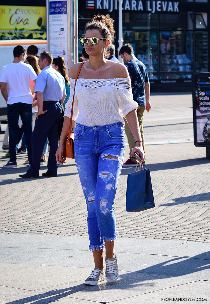 Street style summer women's fashion, how to wear off the shoulder white top, trendy mirror sunglasses, and distressed jeans