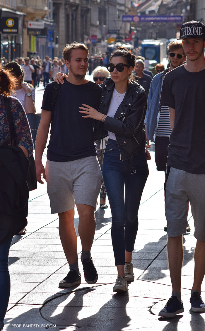 Street style summer 2016, couples street fashion, mens's fashion joggers shorts and a tee, on her: skinny high waist jeasn and biker jacket 